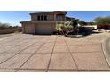 A front yard showing an extra long driveway with pavers leading up to a two car garage at 6904 E Trailridge Cir, Mesa, AZ 85207