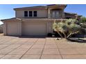 Two-story home boasts a tile roof and attached three-car garage and extra wide driveway at 6904 E Trailridge Cir, Mesa, AZ 85207