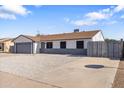 Charming single-story home featuring a gray garage door and a low-maintenance front yard at 7008 W Sierra St, Peoria, AZ 85345