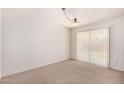 Bright Living room with vertical blinds, neutral carpet, and bright overhead lighting at 8501 E Malcomb Dr, Scottsdale, AZ 85250