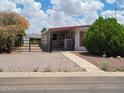 Street view of the single story home with a gate, desert landscaping and a covered carport at 901 S Esperanza Ave, Mesa, AZ 85208