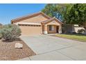 Single Gathering home featuring desert landscaping and a spacious driveway leading to a two-car garage at 1156 N San Benito Dr, Gilbert, AZ 85234