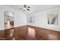 Bright living room with hardwood floors, large window, and a ceiling fan for comfortable living at 1156 N San Benito Dr, Gilbert, AZ 85234