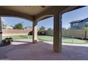 Outdoor patio area featuring a putting green and covered space at 13687 N 151St Ln, Surprise, AZ 85379