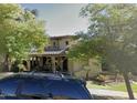 Beautiful two-story home with mature trees and covered front porch at 13687 N 151St Ln, Surprise, AZ 85379
