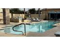Community pool featuring lounge chairs, shade structures, and a fire pit area for residents to relax and socialize at 1477 W Marlin Dr, Chandler, AZ 85286
