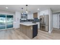 Modern kitchen featuring white cabinets, stainless steel appliances, and a stylish center island at 1530 W Glenrosa Ave, Phoenix, AZ 85015