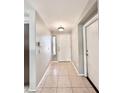Inviting entryway featuring tile flooring, neutral paint, and a modern light fixture at 16176 W Lisbon Ln, Surprise, AZ 85379
