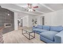 Open-concept living room with wood look tile floors, modern fireplace, and views into the kitchen at 17401 N 16Th Ave, Phoenix, AZ 85023