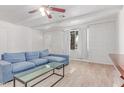 Bright living room with white brick walls, wood look tile floors, and a cozy blue sectional sofa at 17401 N 16Th Ave, Phoenix, AZ 85023