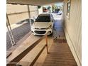 Carport view with white vehicle parked beneath and a wheelchair ramp for accessible entry at 18026 N Cave Creek Rd # 16, Phoenix, AZ 85032