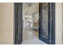 Elegant entryway featuring wrought iron doors opening to the home's interior at 18207 W Sells Dr, Goodyear, AZ 85395