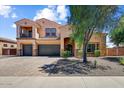 Beautiful two-story home with a three-car garage, balcony, and desert-friendly landscaping at 18207 W Sells Dr, Goodyear, AZ 85395
