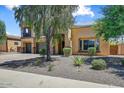 Inviting two-story home with a three-car garage and desert landscaping at 18207 W Sells Dr, Goodyear, AZ 85395