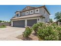 Beautiful two-story home with a three-car garage, desert landscaping, and tile roof at 1847 W Leah Ln, Gilbert, AZ 85233
