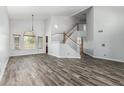 Spacious living room with high ceilings, wood-look tile flooring, and abundant natural light at 1847 W Leah Ln, Gilbert, AZ 85233