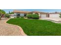 Beautiful front yard features lush lawn, charming brick accents, and a well-maintained landscape at 18820 N 33Rd Ave, Phoenix, AZ 85027
