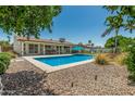 Inviting backyard featuring a sparkling pool, mature landscaping, and ample space for outdoor entertaining at 18820 N 33Rd Ave, Phoenix, AZ 85027