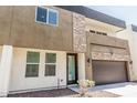 Modern two-story townhome with mixed material facade featuring stone and an attached two-car garage at 2000 N 36Th St # 17, Phoenix, AZ 85008