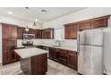 Well-lit kitchen features a center island, stainless steel appliances and dark wood cabinetry at 2000 N 36Th St # 17, Phoenix, AZ 85008