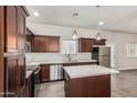 Beautiful kitchen showcasing dark cabinetry, stainless steel appliances, tile floors, and a center island at 2000 N 36Th St # 17, Phoenix, AZ 85008