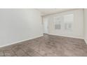 Bright living room with neutral walls, tiled floors, and large windows allowing ample natural light at 2000 N 36Th St # 17, Phoenix, AZ 85008