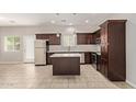 Modern kitchen with island, dark wood cabinets, and stainless steel appliances at 2000 N 36Th St # 20, Phoenix, AZ 85008