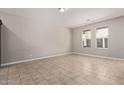 A bright living room with tile floors and natural light from two windows at 2000 N 36Th St # 20, Phoenix, AZ 85008