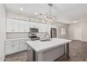 Bright kitchen features an island, stainless steel appliances, and stylish pendant lighting at 2000 N 36Th St # 35, Phoenix, AZ 85008