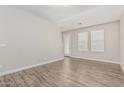 Bright living room with hardwood floors and two windows at 2000 N 36Th St # 35, Phoenix, AZ 85008