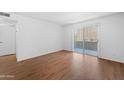 Bright, airy bedroom with wood floors and access to outdoor patio at 2625 E Indian School E Rd # 115, Phoenix, AZ 85016