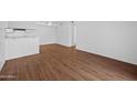 Open-concept living room with wood floors, adjacent to the kitchen at 2625 E Indian School E Rd # 115, Phoenix, AZ 85016
