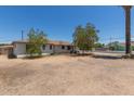 Single story home featuring a front yard with mature trees and a gravel landscape at 3302 W Turney Ave, Phoenix, AZ 85017