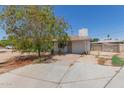 Single story home featuring a front yard with mature trees and a front patio at 3302 W Turney Ave, Phoenix, AZ 85017