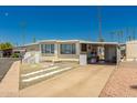 Attractive home with desert landscaping and a covered carport for convenient parking at 4065 E University Dr # 141, Mesa, AZ 85205