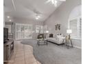 Bright, open living area features vaulted ceiling, neutral paint, plantation shutters, and comfortable furniture for a welcoming ambiance at 4202 E Broadway Rd # 130, Mesa, AZ 85206