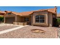 Exterior elevation featuring a desert landscaped yard, sidewalk leading to the front door and a brown two car garage at 4336 E Aspen Ave, Mesa, AZ 85201