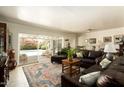 Cozy living room featuring a comfortable sectional sofa, rug, and sliding glass doors to the backyard pool area at 5438 E Avalon Dr, Phoenix, AZ 85018