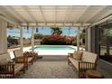 Relaxing covered patio overlooking the backyard swimming pool, perfect for outdoor entertaining and leisure at 5438 E Avalon Dr, Phoenix, AZ 85018