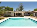 Refreshing backyard swimming pool with steps, surrounded by a patio area and lush landscaping at 5438 E Avalon Dr, Phoenix, AZ 85018