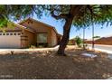 Charming single-story home with a well-manicured yard and a welcoming facade at 6515 W Hughes Dr, Phoenix, AZ 85043