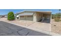 This single-story home offers a convenient carport, desert landscaping, and easy access with a ramp at 6960 W Peoria Ave # 74, Peoria, AZ 85345