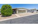 Inviting single-story home featuring desert landscaping, a carport, and a well-maintained exterior at 6960 W Peoria Ave # 74, Peoria, AZ 85345