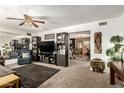 Spacious living room boasts a large TV, built-in shelves, and a comfortable seating area for relaxing at 8602 N 41St Ave, Phoenix, AZ 85051