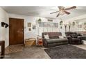 Cozy living room features a plush sofa, a ceiling fan, and natural light, creating an inviting space at 8602 N 41St Ave, Phoenix, AZ 85051