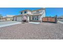 Charming two-story home showcasing a well-maintained gravel yard, solar panels, and an American flag at 10806 W Adam Ave, Peoria, AZ 85373