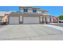 Inviting two-story home displaying a spacious driveway, three-car garage, and roof solar panels at 10806 W Adam Ave, Peoria, AZ 85373