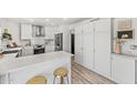 Bright kitchen features white cabinets, stainless steel appliances, and marble countertops at 13626 N 89Th St, Scottsdale, AZ 85260