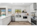 Modern kitchen with stainless steel appliances, quartz countertops, and wood flooring at 13626 N 89Th St, Scottsdale, AZ 85260