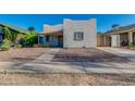 Charming single-story home with neutral stucco, gravel landscaping, and a covered entryway on a clear day at 1409 E Apollo Rd, Phoenix, AZ 85042